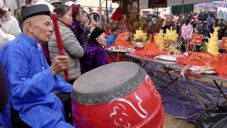 An-old-man-is-playing-drums-at-the-Long-Tong-festival,-held-in-Bac-Son-town,-Lang-Son-province,-Vietnam