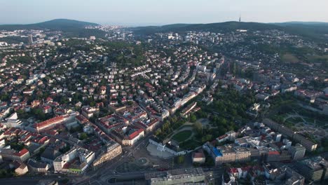 Aerial-footage-of-Bratislava-city-and-castle-captures-the-enchanting-beauty-of-Slovakia's-capital-during-sunrise-and-sunset,-as-the-city-lights-up-the-sky-in-a-magnificent-display