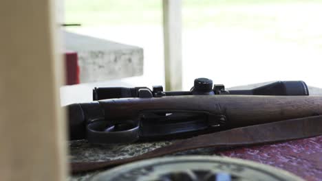 Closeup-Of-A-Wooden-Rifle-On-The-Table-At-The-Firing-Range