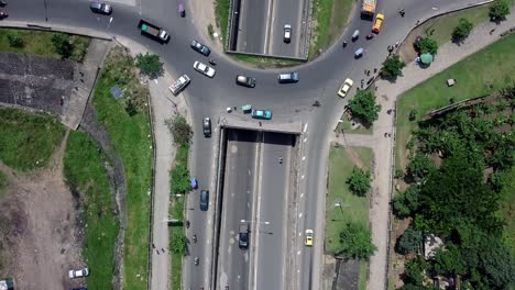 Aerial-view-over-a-highway-and-a-traffic-circle-in-Douala,-Cameroon,-Africa---cenital,-drone-shot