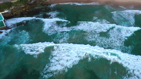 Aerial-top-down-drone-shot-of-the-beach-and-ocean-riptide-currents-at-south-Bondi-beach-Australia