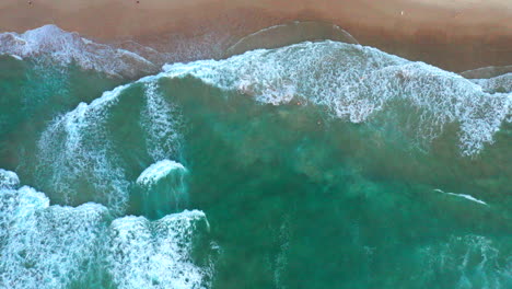 Slowly-moving-to-the-right-aerial-top-down-drone-shot-of-the-beach-and-ocean-riptide-currents-at-Bondi-beach-Australia