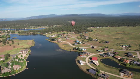 Aerial-View-of-Hot-Air-Balloon-Flying-Above-Lake-and-Landscape-of-Pagosa-Springs-Colorado-USA