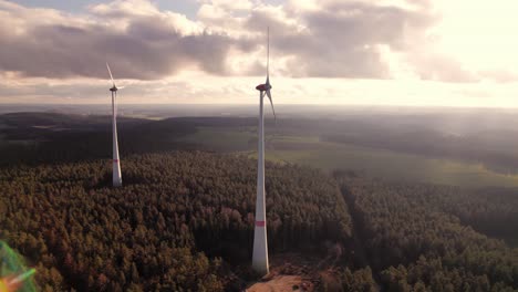 Two-wind-turbine-creating-renewable-engery-at-windy-sunset,-Bavaria-Germany