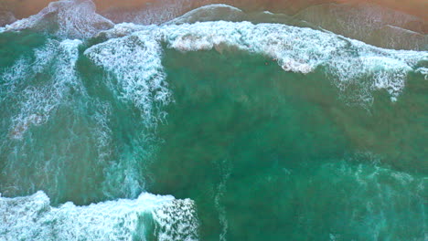 Stationary-aerial-top-down-drone-shot-of-the-beach-and-ocean-riptide-currents-at-Bondi-beachAustralia