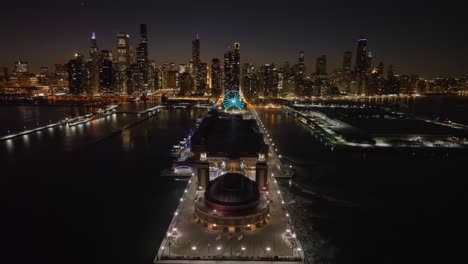 Aerial-view-over-the-illuminated-Navy-Pier,-nighttime-in-downtown-Chicago,-USA