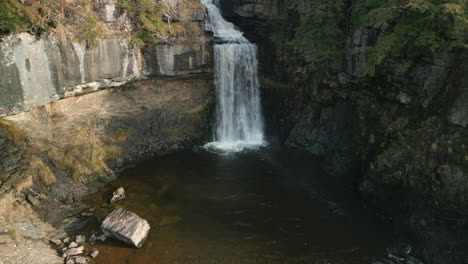Waterfall-high-level-approach-in-winter-sunshine-at-Ingleton-Waterfalls-Trail-Yorkshire-UK