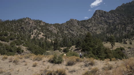 Los-Excursionistas-Caminan-Por-Senderos-Con-Paisajes-Montañosos-Escarpados-En-El-Fondo