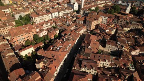 Aerial-Drone-Above-Architecture-of-Venice-Italy,-Red-Tile-Roof-Houses,-Sea-Water-Summer-Landscape-and-Residential-Area,-Water-Channel-and-Basilica