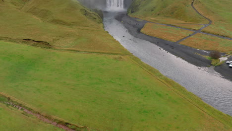 Aerial-reveal-shot-of-Skogafoss-waterfall-during-an-overcast-day