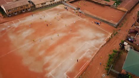 Aerial-view-over-an-urban-street-soccer-game-in-the-city-of-Yaounde,-Cameroon