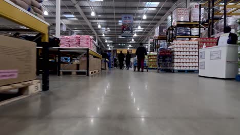 Low-Angle-POV-From-Trolley-Cart-Inside-Wholesale-Costco-Warehouse-Going-Past-Goods