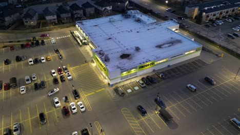 Aerial-shot-of-busy-Freshco-grocery-store-parking-lot-in-Niagara-Falls-at-night