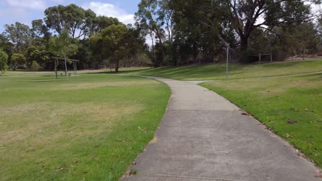 Handheld-Clip-Walking-Around-Green-Parkland,-Blue-Lake-Park-Joondalup-Perth