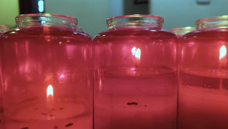Red-orthodox-candles-burning-at-a-church-close-up