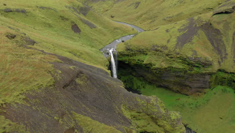 Aerial:-Slow-panning-shot-of-Kvernufoss-waterfall-in-Iceland