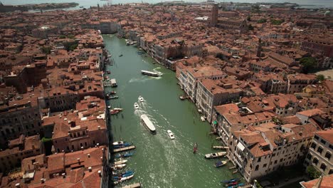 Aerial-Drone-Fly-Above-Boats-Sailing-in-Grand-Canal-of-Venice,-Italy-in-Summer-Warm-Weather,-Gondolas-and-City-Architecture-in-Romantic-Travel-European-Destination