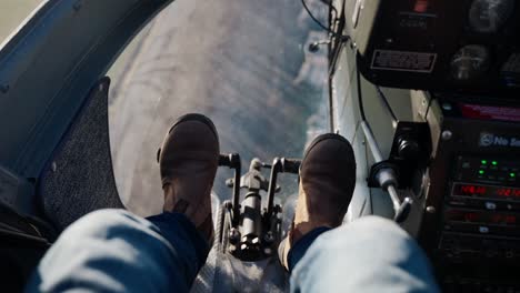 Looking-down-at-the-floor-from-the-front-seat-of-a-helicopter-ride