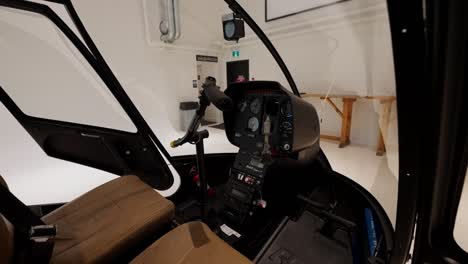 Zoom-in-of-a-helicopter-cockpit,-front-seats,-and-controller