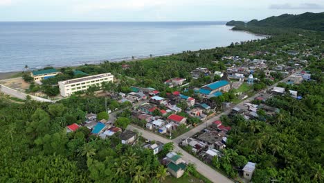 Aerial-Overhead-Drone-shot-of-Coastal-Barangay-with-Calm-Sea-in-background-in-Catanduanes,-Philippines