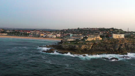Aerial-drone-shot-of-Ben-Buckler-rocks-and-the-ocean-in-Bondi,-Sydney-Australia