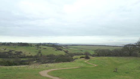 Aerial-view-of-fields-and-mountain-bike-trails-at-Hadleigh-Park,-drone