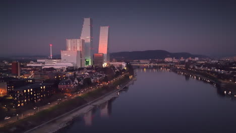 Refelection-in-the-Rhine-river-of-the-ultamodern-Roche-Towers-illuminated-by-the-setting-sun-in-Klein-Basel-in-Switzerland