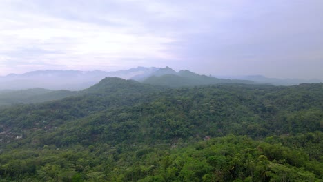 Aerial-view-of-forest-and-hill-with-cloudy-sky---Tropical-landscape,-Asia