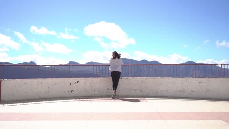 Woman-looking-at-mountains-landscape-at-viewpoint-in-Artenara,-Gran-Canaria,-Spain