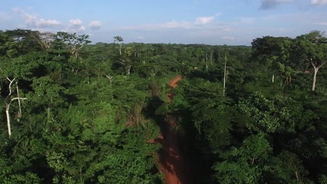 4x4-off-road-truck-driving-on-a-remote-jungle-road,-in-Cameroon,-Africa---Aerial-view