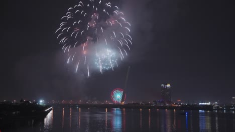 Colorful-fireworks-light-up-sky-for-Lunar-New-Year-and-Tet-holiday-over-Han-River-in-Danang,-Vietnam