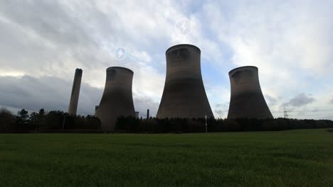 Energy-symbols-flashing-over-multiple-power-station-smokestacks-time-lapse-with-clouds-moving-fast-overhead