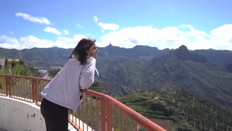 Woman-looking-at-mountains-landscape-at-viewpoint-in-Artenara,-Gran-Canaria,-Spain