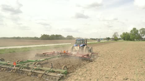 Farmer-in-tractor-cultivating-crop-in-field-take-7