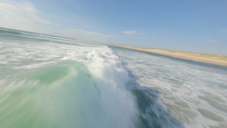 Drone-flying-low-over-ocean-waves-foam,-Soustons-in-France
