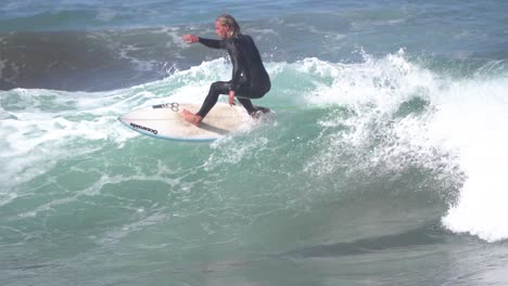 Gran-Canaria-Spain---February-9-2023:-Surfers-try-to-ride-waves-at-Las-Canteras-beach-in-Las-Palmas-de-Gran-Canaria,-Spain