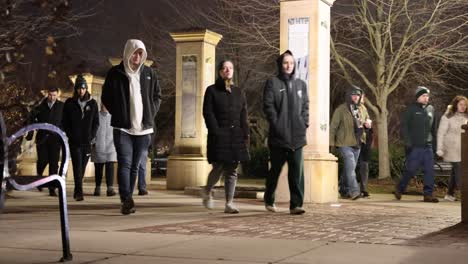 Michigan-State-University-Vigil-people-walking-through-campus-Closer-shot