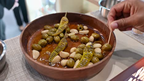 Closeup-of-grilled-green-olive,-Garlic-and-Green-Chilli-pickles-are-displayed-during-the-Gulf-Food-2023