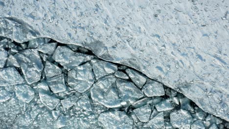 Aerial-top-down,-polar-ice-sheet-cracked-from-melting-caused-by-climate-change