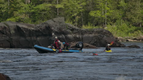 Emergency-boat-rescuing-kayakkers-on-white-water-rapids