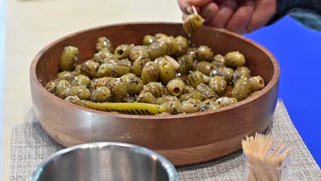 Grilled-green-olive-pickles-are-displayed-during-the-Gulf-Food-exhibition,-United-Arab-Emirates