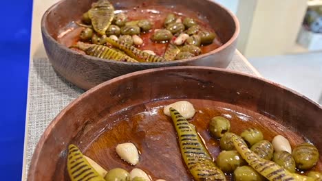 Closeupsof-grilled-green-olive-pickles-are-displayed-during-the-Gulf-Food-exhibition,-United-Arab-Emirates