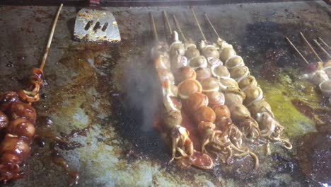 The-Street-food-seller-are-making-roasted-squid-skewer-with-tomato-and-chili-sauce