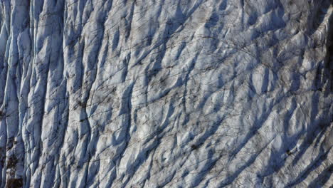 Aerial:-Top-down-view-of-crevasses-on-Svinafellsjokull-glacier-in-Iceland-during-a-sunny-day