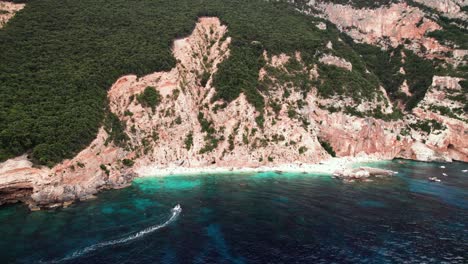 Aerial-view-of-Mariolu-white-sand-beach-on-steep-rock-coast,-Sardinia