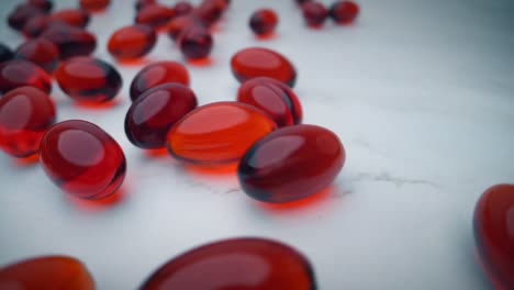 Red-krill-oil-capsules-bouncing-over-a-white-table