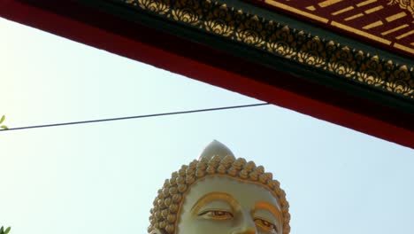 Giant-Buddha-reveal-shot-at-Wat-Paknam-Bhasicharoen-Bangkok-Thailand-golden