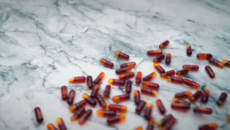 Red-krill-oil-capsules-being-poured-out-on-to-a-a-white-marble-table