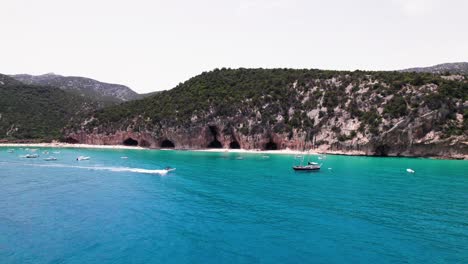 Aerial-seascape-of-speed-boat-cruise-on-turquoise-mediterranean-sea,-Sardinia-coast