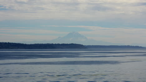 Magnificent-view-of-the-massive-Mount-Rainier-seen-from-Seattle-and-the-ferry-over-the-Puget-Sound